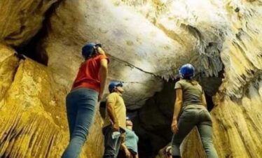 Small group admiring rock formations inside cavernas del venado