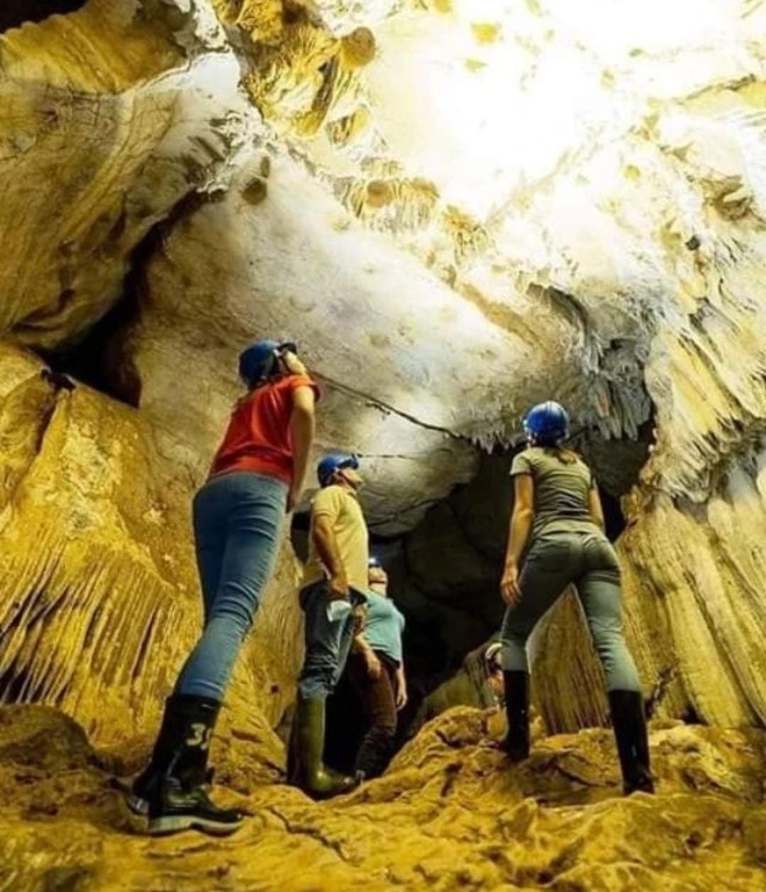 Small group admiring rock formations inside cavernas del venado