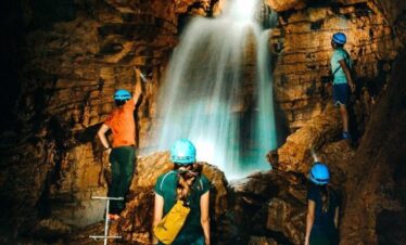 Small group admiring subterranean waterfall in Cavernas del Venado